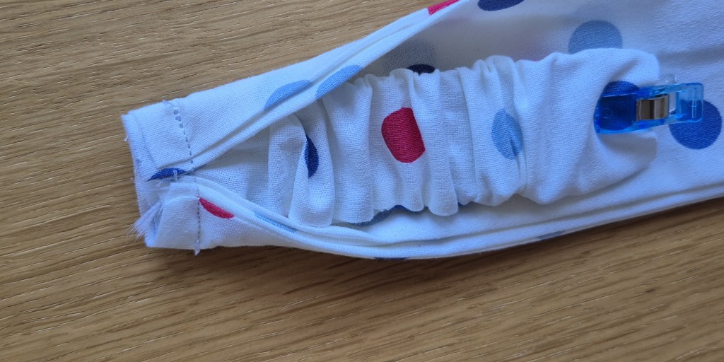 Close-up of sewing a twisted headband from a fat quarter, beginner-friendly project.