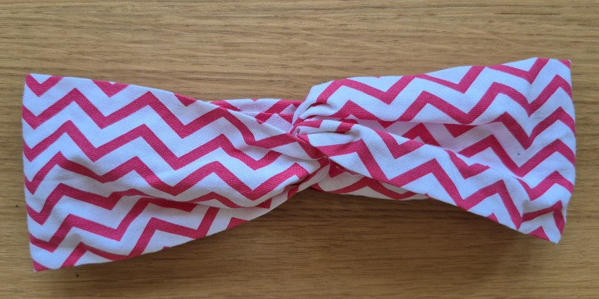Completed DIY twisted headband made from a fat quarter fabric, ready to wear.