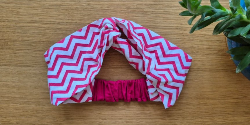 Completed DIY twisted headband made from a fat quarter fabric, ready to wear.